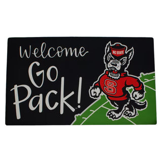 Decorative mat with NC State wolfpack logo and 'Welcome Go Pack!' text on a black background.