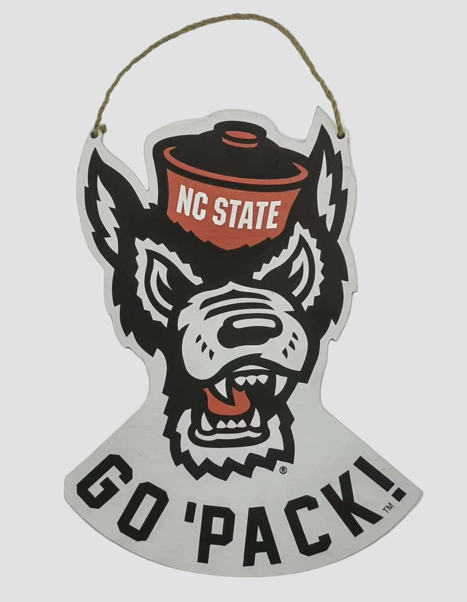 Decorative door sign with NC State wolf logo and 'Go Pack!' text on a white background