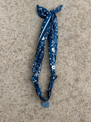 Blue patterned scarf necklace with UNC charm. 