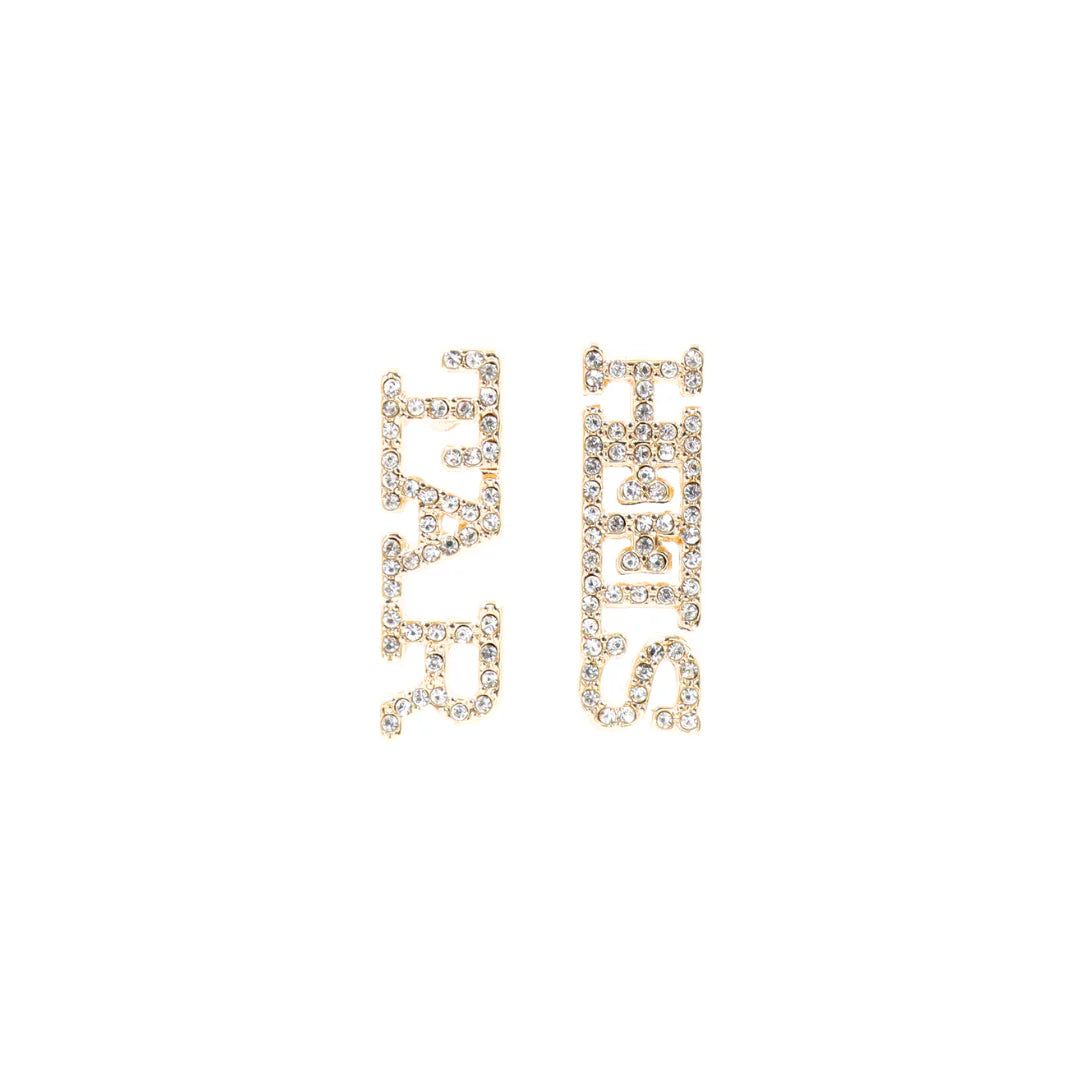 Pair of gold earrings that read "TAR HEELS" on a white background