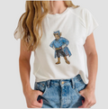 Person wearing a white t-shirt with a water color blue devil design on a plain background