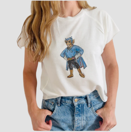 Person wearing a white t-shirt with a water color blue devil design on a plain background