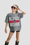 Youth wearing a Rhinestone NC State Wolfpack t-shirt on a sidewalk.