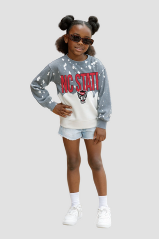 Child wearing a gray sweatshirt with 'NC State' and a logo, white shorts, and white sneakers on a light gray background.